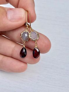 Garnet Earrings, January Birthstone, Gray Moonstone and Garnet Drop Earrings, Gray and Red Jewelry, Gold Jewelry, Birthday Gift for January These rich looking earrings feature gray moonstone free form gemstones bezeled in gold filled and suspended from them are flawless quality garnet teardrops wire wrapped in gold filled. The earrings come suspended from gold filled lever back ear wires. These earrings are very light weight, they are a great choice for fall and winter outfits and they balance b Fall And Winter Outfits, Garnet Drop Earrings, Labradorite Earrings, Red Jewelry, January Birthstone, Jewelry Birthday, Garnet Earrings, Chic Jewelry, Jewelry Gold