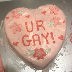 a cake shaped like a heart with the words ur gay written in frosting on it