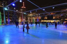 people skating on an ice rink at night