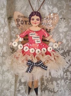 an ornament with a girl in a red dress and name tag on it