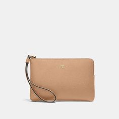 Crafted from luxurious crossgrain leather, this petite wristlet secures your must-have cards and cash for nights out. Its zip-top closure keeps essentials safely tucked away while its wrist strap allows full hands-free functionality. Interior pockets cordoned two slots to discreetly carry IDs and payment cards. At just 6 1/4' long, it slips easily into a handbag without weighing it down so you have piece of mind wherever the evening leads. An effortlessly chic way to stay hands-free in style. Classic Pouch Wallet With Wrist Strap, Classic Bags With Wrist Strap, Beige Business Wallet, Classic Coach Clutch With Card Slots, Leather Wallet With Wrist Strap For Formal Use, Leather Wallet With Wrist Strap For Formal Occasions, Classic Clutch With Wrist Strap For Travel, Formal Leather Wallet With Wrist Strap, Classic Formal Clutch With Wrist Strap