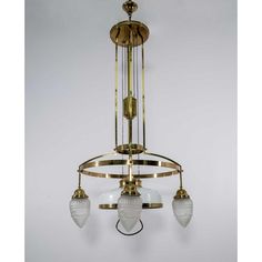 an antique brass chandelier with glass shades