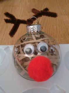 a glass ornament with a red nose and brown nose on it's side