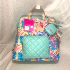 Brand New With Tags Betsey Johnson Bj Luv Lb Tye Dye Tie Dye Rainbow Diamond Quilted Front Teal Back Pack Backpack Womans Bag Zip Closure Inside Compartments / Smart Phone Compartments Top Handle Free Accessories Case / Holder Adjustable Straps 13.5” X 14 X 5”.5 Top Handle 3.5” X 3” Brand New With Tags Bnwt Please Feel Free To Shop Around My Closet Message Me To Bundle And Save On Shipping Thank You Marie’s Home And Body Multicolor Backpack With Detachable Strap, Back To School Multicolor Pouch Bag, Trendy Multicolor Backpack For On-the-go, Trendy Multicolor Backpack For Daily Use, Yellow Backpack, Clear Backpack, Tie Dye Rainbow, Floral Backpack, Quilted Backpack