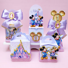 a set of minnie mouse party favors and gift boxes with matching bows on pink background