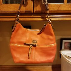 Dooney And Bourke Orange Leather Purse. It Measures 9x12x4 With An Adjustable Drop Up 10". It Has An Open Compartment Inside With Side Pockets And A Zipper Enclosure On Top. One Corner Has Some Very Minor Wear Noted In The Picture. Otherwise In Excellent Condition. Hobo Purses Dooney & Bourke, Dooney And Bourke, Orange Leather, Dooney & Bourke Bags, Dooney & Bourke, Leather Purse, Dooney Bourke, Color Orange, Leather Purses