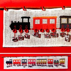 two cross stitched pictures of trains on a red wall and hanging from clothes pegs