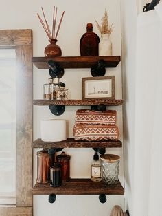 some shelves with candles and other items on them