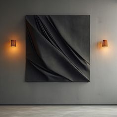 an abstract painting hangs on the wall next to two lamps