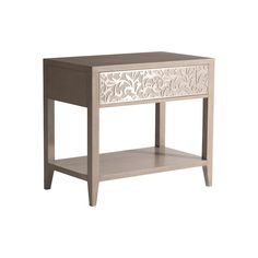 a white and brown table with drawers on each side, one drawer has an intricate design