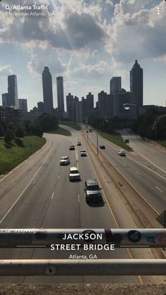 an overhead view of a highway with cars on it and the skyline in the background