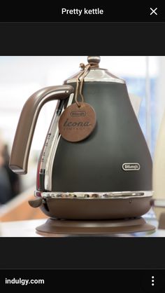 a coffee pot sitting on top of a wooden table