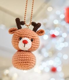 a crocheted reindeer ornament hanging from a string