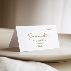 a place card sitting on top of a white plate