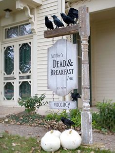 a sign that is sitting in front of a house with crows on it and the words, 24 cleverer outdoor halloween decorations