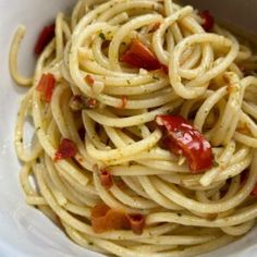 a white bowl filled with pasta and sauce