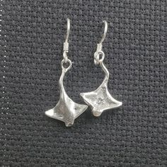 These stingray earrings are made by us out of nickle free sterling silver.  Each stingray measures 15/16" tall x 5/8" wide. Stingray Jewelry, Silver Adjustable Fish Hook Earrings, Bat Ring, Middle Finger Ring, Green Rings, Ring Photos, Stingray, Celtic Knot, Metal Rings