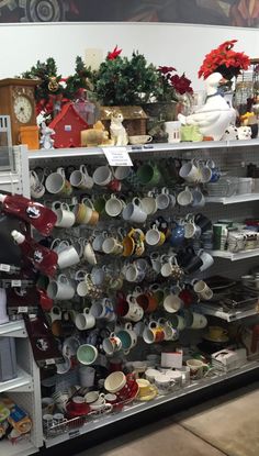 the shelves are filled with many different types of cups and saucers, all stacked on top of each other