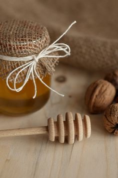 a jar of honey and some nuts on a table