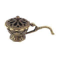 an ornate brass teapot on a white background