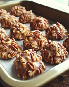 there are many pecan cookies on the baking sheet