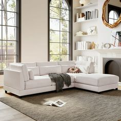 a living room with a large white sectional couch