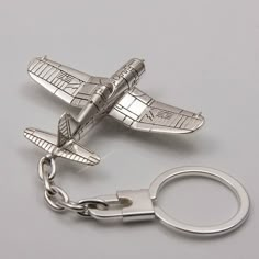 a metal key chain with a plane on it