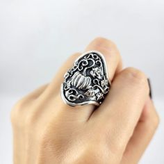 The Magic Pumpkin ring is truly something special- full of hand sculpted details and made of heavy solid sterling silver, it takes statement ring to a whole new level. The magical pumpkin sits at the focal point of a curvy wide band ring, curling vines and leaves follow the shape of the ring around the sides, tapering off toward the back. The very back of the band is cinched slightly for comfort. The background is heavily oxidized for drama (which fades off at the back), and the sculpted details Handmade Ornate Rings, Unique Hand-cast Skull Ring, Pumpkin Ring, Wide Band Rings, Wide Bands, Makers Mark, Band Rings, Statement Rings, Gemstone Rings