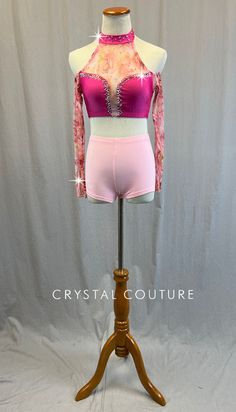 Mock neck halter top has Pink sweetheart neckline and collar. Light Pink and Green floral printed mesh on upper chest, down center of sternum, and long sleeves with cold shoulder cutouts. This is a top only and does not come with any bottoms. 3.5 Gross of Silk AB 20ss and Rose AB 20ss and 30ss Rhinestones! **Costume in image is an AS, Photographed on an AS/AM Mannequin with Measurements of: Bust 35", Ribcage 30", Waist 25", Hip 34", Girth 57" Embellished Stretch Mesh Top For Summer, Fitted Pink Tops With Rhinestones, Pink Fitted Tops With Rhinestones, Pink Long Sleeve Stretch Mesh Top, Pink Stretch Mesh Top With Long Sleeves, Fitted Pink Blouse With Sheer Sleeves, Spring Pink Rhinestone Tops, Spring Fitted Mesh Top With Rhinestones, Fitted Mesh Top With Rhinestones For Spring