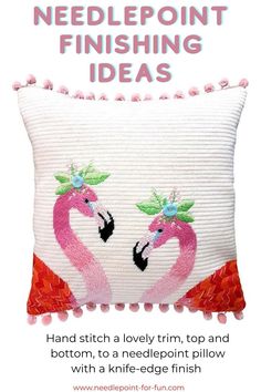 a white pillow with pink flamingos on it and pom poms around the edges