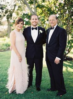 two men and a woman in formal wear