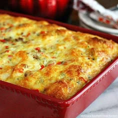 a red casserole dish filled with cheesy bread