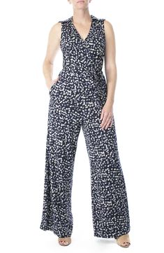 Sleek, artistic graphic prints accentuate a surplice neckline jumpsuit for an en vogue, chic attire. - Surplice neck with spread collar- Sleeveless- Waist tie- 2 front slash pockets- Allover print- Approx. 62" length, 30" inseam (size M)- ImportedAvailable in:- Polka dot print (BLACK-IVORY, NAVY-IVORY)- Floral print (NAVY MULTI)- Geo print (BLACK/ WHITE) Model's stats for sizing:. Height: 5'10". Bust: 34". Waist: 24". Hips: 34" Model is wearing size S. Machine wash cold 95% polyester, 5% spandex Elegant Printed Sleeveless Jumpsuits And Rompers, Elegant Sleeveless Printed Jumpsuits And Rompers, Casual Strapless Sleeveless Jumpsuit With Tie Waist, Elegant Floral Print Jumpsuits And Rompers For Work, Elegant Floral Print Jumpsuits For Work, Chic Floral Print Jumpsuits For Work, Chic Floral Jumpsuits And Rompers For Work, Chic Wide Leg Jumpsuits And Rompers With Floral Print, Summer Workwear Printed Jumpsuits And Rompers