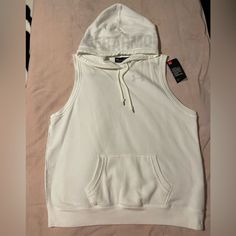 Solid White Color Sleeveless Hoodie W/ Kangaroo Pocket, Brand New White Cotton Athleisure Vest, Casual Sleeveless Hoodie For Workout, White Cotton Streetwear Vest, White Cotton Vest For Streetwear, Casual Hooded Tank Top For Sports, Under Armour Sporty Streetwear Tops, Sporty Under Armour Tops For Streetwear, Sporty White Vest For Streetwear, Sleeveless Cotton Top With Drawstring Hood