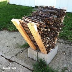 a pile of wood sitting on top of a cement block