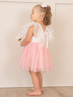 This sweet Pink & White Flutter Tulle Dress will have your little girl twirling with joy! Designed specially for MNC, the delicate flutter sleeves and lined tulle skirt add a whimsical touch, while the delicate lace bodice adds a fun and glamorous element. Perfect for any special occasion, this dress will make your little one feel like a princess! Fits true to size. 97% Cotton / 3% Spandex Accessories sold separately. Suggest bow color #1 and #32 Import. Functional tie on back of dress. Aurora i Flutter Sleeve Tulle Dress With Ruffles, Tulle Dresses With Ruffles And Flutter Sleeves, Tulle Dress With Ruffles And Flutter Sleeves, Spring Princess Dress With Ruffles And Tulle, Tulle Dress With Flutter Sleeves For Dress-up, Tulle Dress With Flutter Sleeves For Party, Summer Tulle Dress With Flutter Sleeves, Ruffled Tutu Dress For Dress-up, Princess Tutu Dress With Ruffles