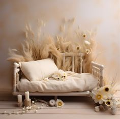 a white bed with flowers and candles on the floor in front of a beige wall