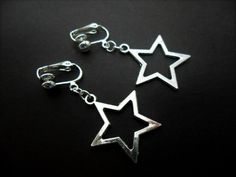 This a pair of pretty little tibetan silver dangly star clip on earrings. Measure approx. 3cm from top of hook to bottom of earring. These earrings are not for pierced ears. Freshly made by me and unworn. Thanks for looking!! Silver Star Clip-on Earrings For Gift, Nickel-free Metal Star Earrings, Nickel-free Star-shaped Metal Earrings, Nickel-free Star Shaped Metal Earrings, Silver Star-shaped Hoop Earrings, Adjustable Star-shaped Metal Earrings, Metal Dangle Earrings With Star Charm, Handmade Silver Star Earrings, Silver Dangle Clip-on Jewelry