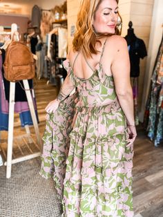 Get ready to turn heads with the Lina abstract floral maxi! This tiered maxi dress features a beautiful abstract floral print and ruffle detailing, adding a touch of whimsy to your look. Look effortlessly stylish and playful in this statement piece! relaxed fit small fits 0-6 medium fits 8-12 large fits 12-16 100% POLYESTER imported Green Floral Ruffled Dress For Beach, Green Floral Ruffled Dress For The Beach, Green Floral Dress With Ruffles For Beach, Tiered Printed Dress For Garden Party, Breezy Tiered Dress With Ruffle Hem For Spring, Bohemian Tiered Maxi Dress For Spring, Pink Abstract Print Maxi Dress For Summer, Pink Maxi Dress With Abstract Print For Summer, Green Breezy Maxi Dress