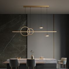 a modern kitchen with marble counter tops and gold accents, along with hanging pendant lights