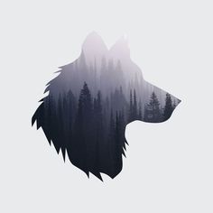 a wolf's head with trees in the background and foggy sky behind it