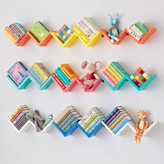 colorful bookshelves and toys are arranged on a white surface