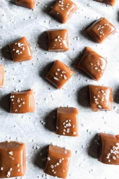 chocolate caramels with white sprinkles and text overlay that reads delicious whiskey salted caramels