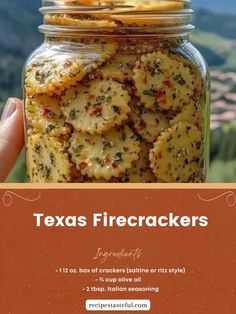 a jar filled with crackers sitting on top of a table next to a mountain