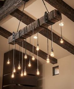 the light bulbs are hanging from the beam in the room with wood beams on it