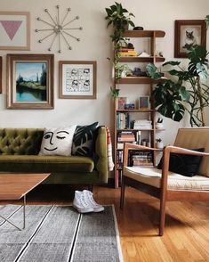 a living room filled with furniture and pictures on the wall