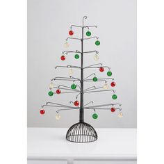 a metal christmas tree with ornaments on it