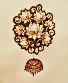 an intricately designed wall hanging on the side of a white wall with gold accents