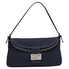 This Fendi Baguette Bag is reminiscent of the reemerging '00s trend. The bag is constructed with navy blue cotton and features a slender silhouette, silver-tone hardware, white contrast-stitching, flat leather shoulder strap and a front flap with magnetic closure with a navy, blue, and cream striped cotton-lined interior. A large metal plaque offers blue, white, and black hues within a dimensional wave-print effect, creating the Italian label's signature FF emblem at its borders. COLOR: Navy MATERIAL: Cotton ITEM CODE: 240826796018 MEASURES: H 7” x L 13” x D 3” DROP: 8” CONDITION: Very good - light marks to interior.. Appears rarely used. Exterior is pristine. Made in Italy Denim Baguette Bag, Fendi Baguette Bag, Navy Bag, Wave Print, Baguette Bag, Blue White And Black, Metal Plaque, Black Bag, Fendi Baguette