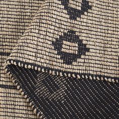 closeup of the black and white pattern on a fabric textured with woven thread